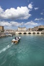 Syracuse, Italy. A boat crosses the canal in the city.