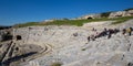 Group of tourists visiting the Greek theater in Syracuse, Sicily