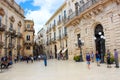 Syracuse, Sicily, Italy - Apr 10th 2019: People walking on the Piazza Duomo Square in the historical center. The center is located