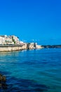 Syracuse, Sicily, Italy Ã¢â¬â August 23, 2018 : Panoramic view of the Ortigia waterfront in Syracuse with the blue sky background Royalty Free Stock Photo