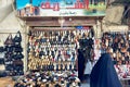 Syria. Damascus. A veiled woman looking at a shoes shop