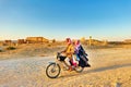 Syria. A family on motorbike among the ruins of the ancient city of Palmyra