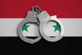 Syria flag and police handcuffs. The concept of observance of the law in the country and protection from crime
