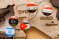 Syria, Iraq, Israel, Libanon, Iran flags on the push pins and red thread on the wooden map, close up