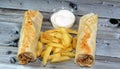 Syrian recipe cuisine background, chicken shawerma or shawarma tortilla wrap with onion, tomato, lettuce and garlic sauce in