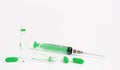 Syringe, ampules and green pills on white background. Medical treatment and vaccination concept.