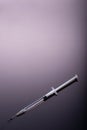 Syringe on black background