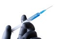 Syringe with blue liquid and a needle in a hand