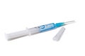 Syringe with blue liquid and a needle isolated