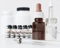 Syringe, different white medical bottles, the blister packings of tablets  on a white background. Royalty Free Stock Photo