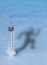 The syringe with doping and the athlete`s shadow