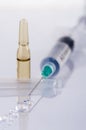 Syringe with drops of medicament and ampule Royalty Free Stock Photo