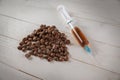 The syringe filled with coffee and coffee beans