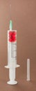 Syringe filled with red white pill Royalty Free Stock Photo