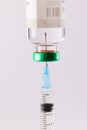 Syringe filling from vial of clear liquid such as insulin, on white background Royalty Free Stock Photo