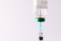 Syringe filling from vial of clear liquid such as insulin, on white background with copy space Royalty Free Stock Photo