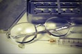 Syringe in fragile glass with steel needle and the glasses of th Royalty Free Stock Photo