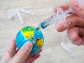 Syringe giving an injection to planet Earth Royalty Free Stock Photo