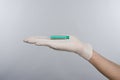 Syringe hand in glove Royalty Free Stock Photo