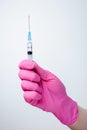 Syringe in hand in medical pink glove. Injectable vaccination. Medicine Royalty Free Stock Photo