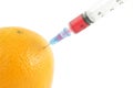 Syringe injecting in orange