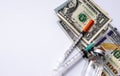 Syringe injection with stethoscope on Chinese bill money and Dollar. Preventive medications for Coronavirus 2019-nCov concept. Spe