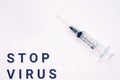 Syringe for injection on a white background with the words STOP VIRUS