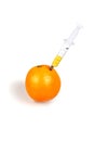 Syringe inserted into an orange Royalty Free Stock Photo