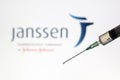 Syringe and Janssen logo on the background. Coronavirus, Covid-19 vaccine concept