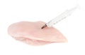 Syringe with liquid being injected to a piece of meat Royalty Free Stock Photo