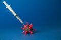 Syringe with liquid medicine shot to corona virus cell minimal creative concept. Space for copy