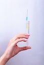 Syringe, medical injection in hand, palm or fingers. Medicine plastic vaccination equipment with needle. Nurse doctor Royalty Free Stock Photo