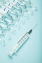 Syringe and medicine ampoules on a blue background