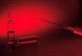 Syringe with the needle and ampule with medicine on red background