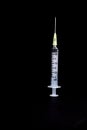 Syringe with needle on black background