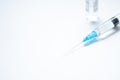 Syringe with needle and cover or top, vial or phial on a white empty space background