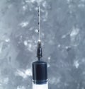 A syringe with a needle filled with crude oil. Royalty Free Stock Photo