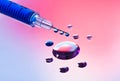 Syringe needle with fluid drops Royalty Free Stock Photo