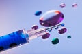 Syringe needle with fluid drops and droplets Royalty Free Stock Photo