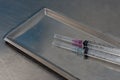 Syringe with needle on a steel tray Royalty Free Stock Photo