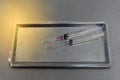 Syringe with needle on a steel tray Royalty Free Stock Photo