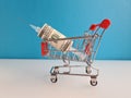 Syringe with needle wrapped in hundred dollars in shopping cart