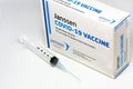 A syringe next to the Janssen Covid-19 vaccine box