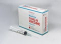 A syringe next to the Moderna Covid-19 vaccine box