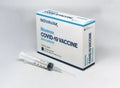 A syringe next to the Novavax Covid-19 vaccine box