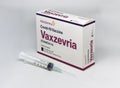 A syringe next to the Vaxzevria Covid-19 vaccine box