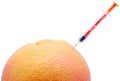 Syringe and orange. Royalty Free Stock Photo