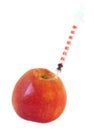 Syringe in red apple, isolated on white background Royalty Free Stock Photo