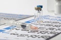 Syringe and Several Vials Vaccine on a Calendar