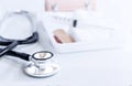 syringe, stethoscope, adhesive bandages and medical gauze bandage on a white table. Medical devices for the treatment of patients.